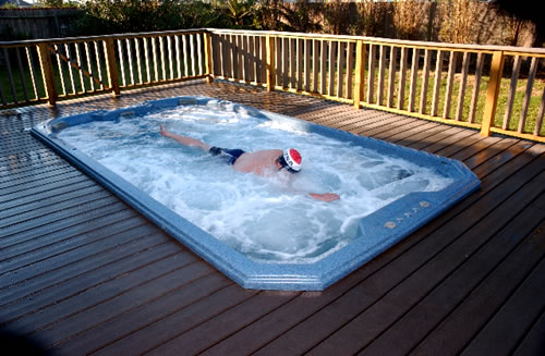 swim-spa-in-deck-swith-man-swimming-against-the-water